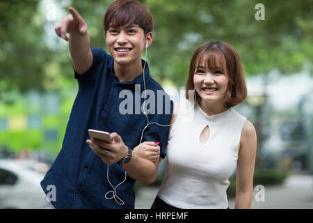 Happy young couple listening to music Stock Photo