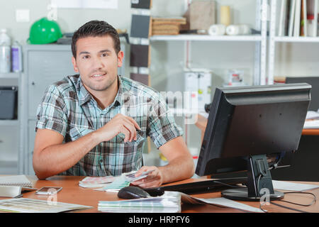 Designer sat at his desk Stock Photo