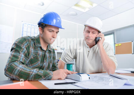 Two architect looking over plans Stock Photo