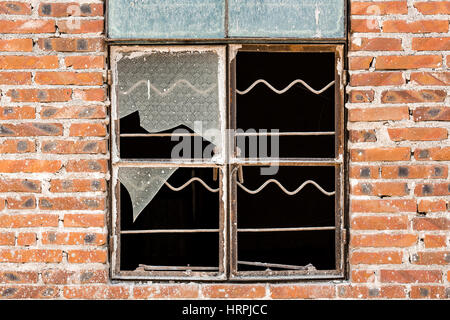 Broken window on a brick wall Stock Photo