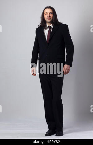 young man with long hair on costume portrait in studio Stock Photo