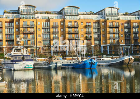 Boats reflected in the waters of regenerated St Katherines Dock in London. Stock Photo