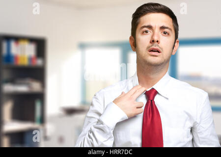 Sweating businessman due to hot climate Stock Photo