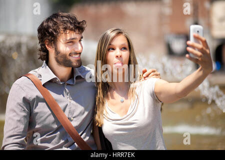 Couple of turists taking a selfie in the city Stock Photo