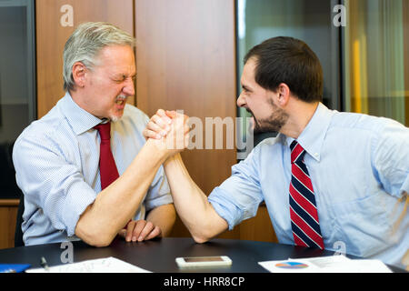 Arm wrestling between businessmen Stock Photo