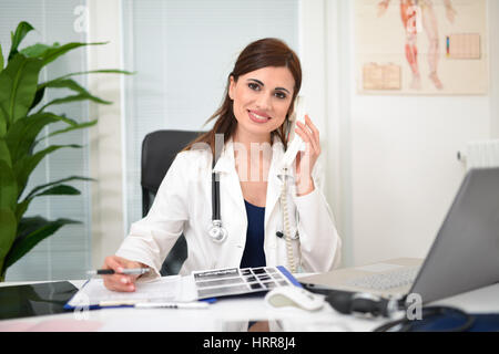 Portrait of a doctor talking on the phone in her studio Stock Photo