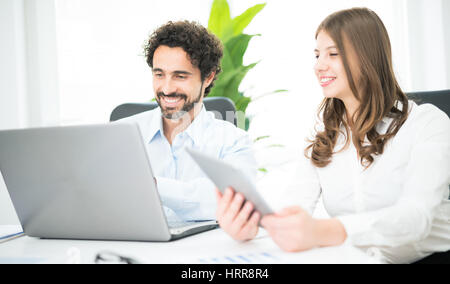 Business people at work in their office. Focus on the man Stock Photo