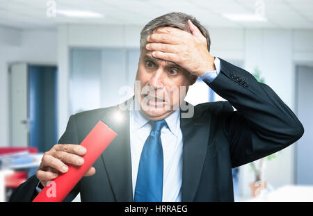 Businessman worried for the imminent explosion, business risk concept Stock Photo
