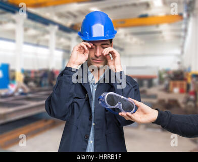 Worker suffering for a splinter in his eye Stock Photo