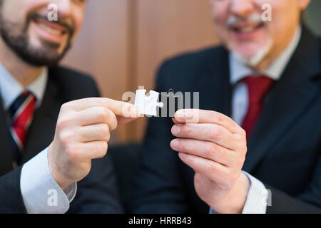 Business concept, businessmen putting puzzle pieces together Stock Photo