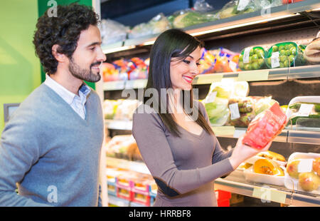 Couple choosing food in a supermarket Stock Photo