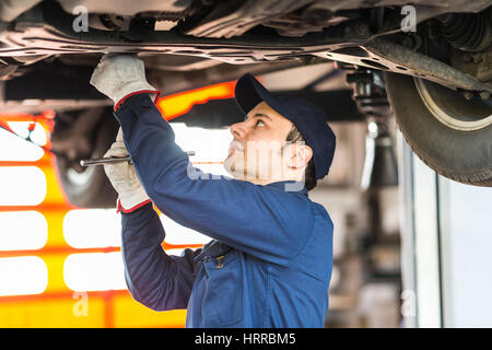 Portrait of a mechanic repairing a car in his garage Stock Photo