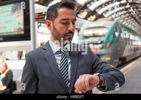 Commuter looking at his watch while waiting his train Stock Photo
