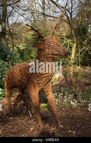 UK, England, Cheshire, Scholar Green, Rode Hall, Gardens, Old Wood, deer willow sculpture amongst snowdrops Stock Photo