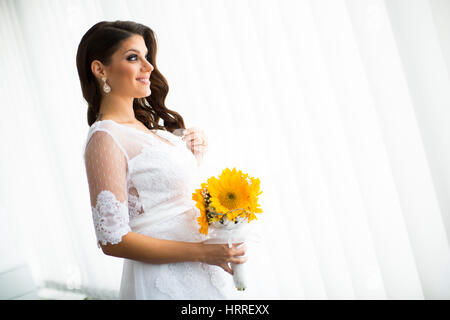 Pregnant bride with a bouquet of sunflowers Stock Photo