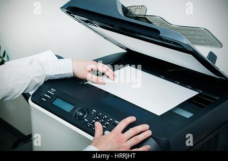 Man using scanner multifunction device in office Stock Photo