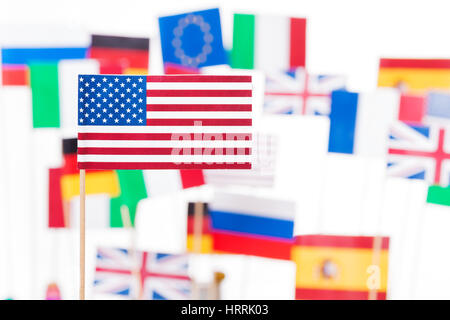 Small flag of America against flags of European Union member-states and Russia