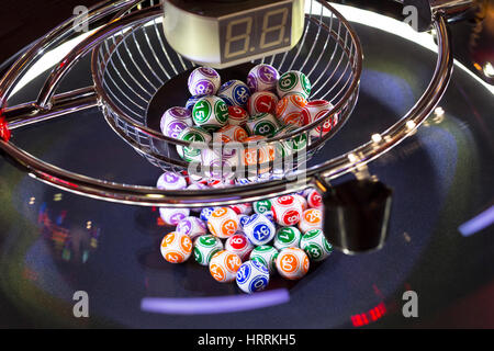 Colourful lottery balls in a rotating bingo machine. Stock Photo