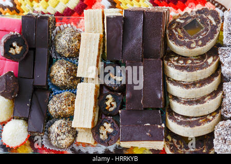 Colorful and delicious home made small cakes arranged on glass plate for celebration of the Saint day Stock Photo