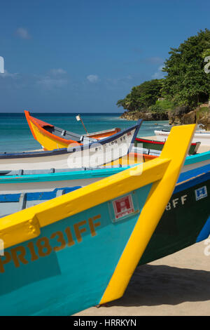 ROW OF BRIGHTLY PAINTED YOLA FISHING BOATS CRASH BOAT BEACH AGUADILLA PUERTO RICO Stock Photo