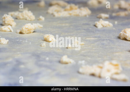 Homemade Phyllo or strudel dough with cheese on a home table cloth ready for cheese burek pie or other kind of traditional pastry. Stock Photo