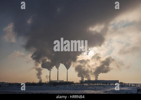 Silhouette of coal plant with gray smoke. Environment pollution by power plants. Perfect industrial background. Free space for text on gray smoke back Stock Photo