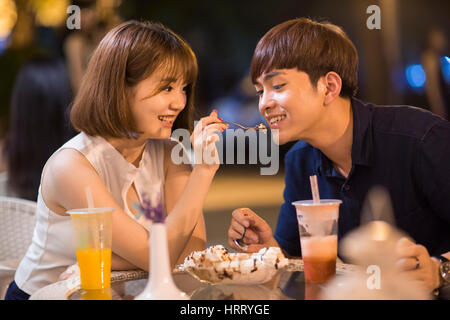 Happy young couple eating ice cream Stock Photo