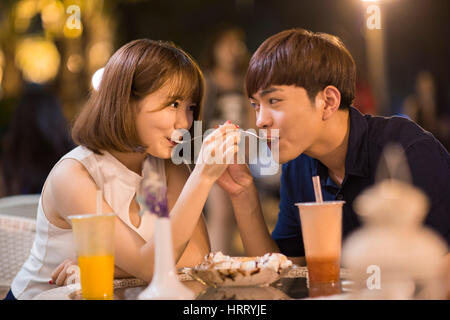 Happy young couple eating ice cream Stock Photo