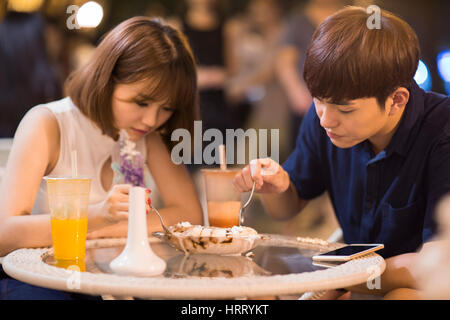 Happy young couple eating ice cream Stock Photo