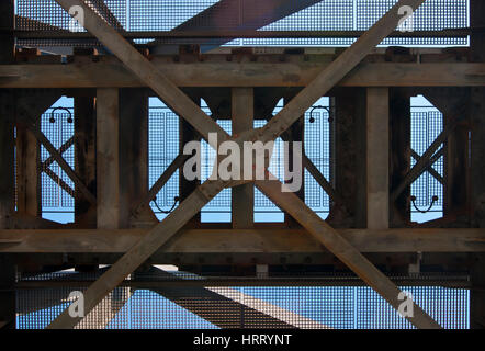 A late-19th century old steel bridge deck - decking structure composed of riveted beams, girders and cross-bracing, view from below Stock Photo