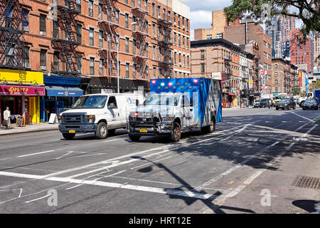 NEW YORK CITY - SEPTEMBER 26, 2016: Ambulance with emergency light and a small truck on 9th Avenue and 51st W Street in Hell's Kitchen on Manhattan Stock Photo