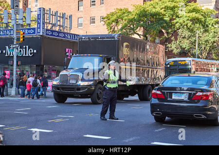 NEW YORK CITY - OCTOBER 06, 2016: A NYPD traffic officer conducting the traffic on 9th Avenue in Chelsea area Stock Photo