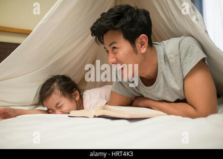 Little girl reading a book with father Stock Photo