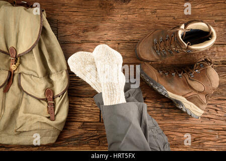 Taking a break after hiking on wooden floor Stock Photo