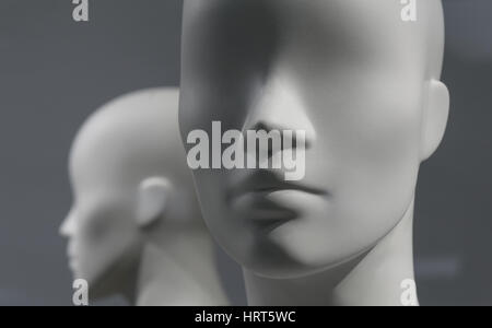 Smooth grey Mannequins in a shop window Stock Photo