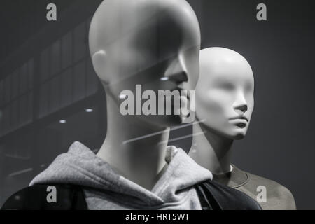 Smooth grey Mannequins in a shop window Stock Photo