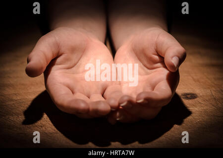 Open hands begging for Help on the wooden table Stock Photo