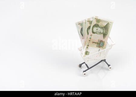 1 Yuan bills / banknotes in shopping cart / trolley against light background. Metaphor for Chinese economy, budget, spending power, consumer spending. Stock Photo