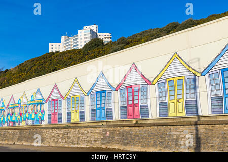 Painting of the beach huts and land train on the side of building, the shed for housing the landtrain, between Bournemouth and Boscombe piers, Dorset Stock Photo