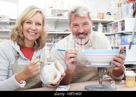 Mature Couple Enjoying Pottery Class Together Stock Photo