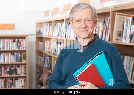 Mature Male Student Studying In Library Stock Photo