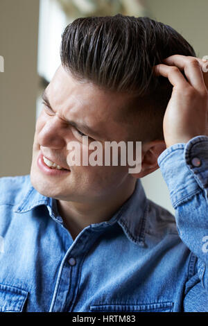 Shot Of Young Woman Itching Scalp Stock Photo