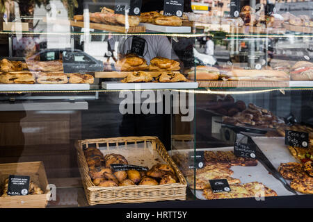 Bakery and pastry shop display window with variety of breads, pies, traditional Spanish empanadas, on Maisonnave Avenue of Alicante, Costa Blanca, clo Stock Photo