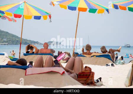 Thailand, Phuket - 19 February 2017 : Patong beach. people are under umbrellas on the beach Stock Photo