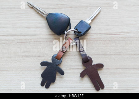 Car key and leather keychain on the floor. Stock Photo
