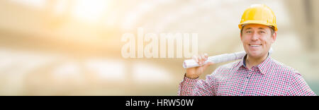 Handsome Adult Male Contractor Holding Constructions Plans with Room For Text. Stock Photo