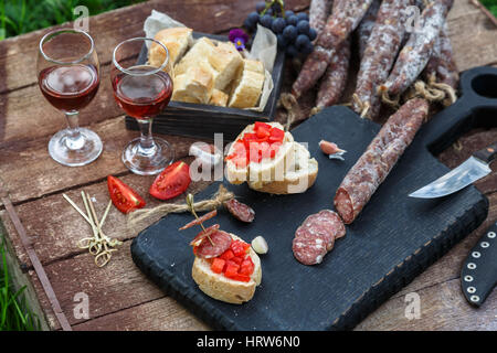 Homemade dried, smoked sausage for an appetizer or a delicious meal - organic meat. Stock Photo