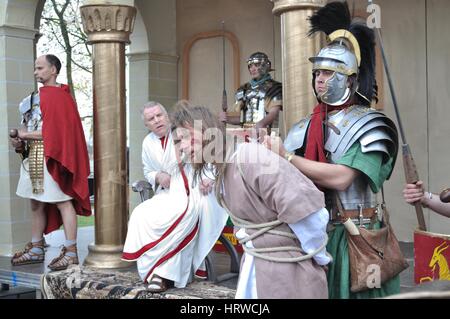 Actors reenact the trial of Jesus in praetorium before Pontius Pilate, during the street performances Mystery of the Passion. Stock Photo