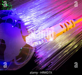 glass earth with network against fiber optic background Stock Photo