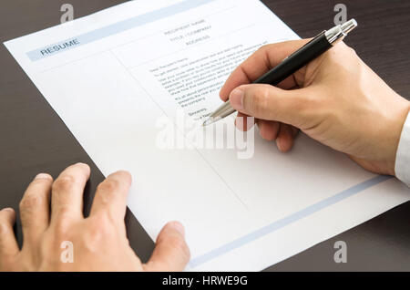 Close-up Businessman or job seeker signing on resume form. Stock Photo